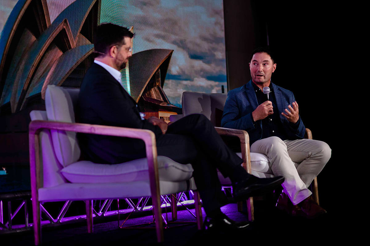 A photo of Ashley Diffey, Ping Identity Head of APAC and Japan, taking part in a fireside chat on stage with Len Nally, Service Owner, Identity and Access Management at Bendigo and Adelaide Bank.
